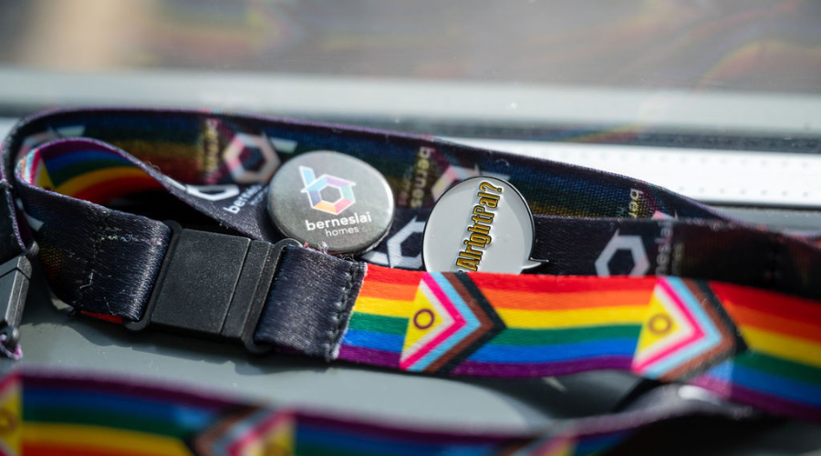 A Pride Berneslai Homes lanyard and keyring on a desk.