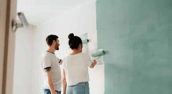 Couple Painting A Wall