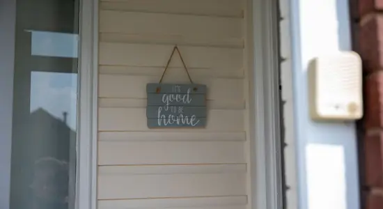 A sign on a home that says it's good to be home