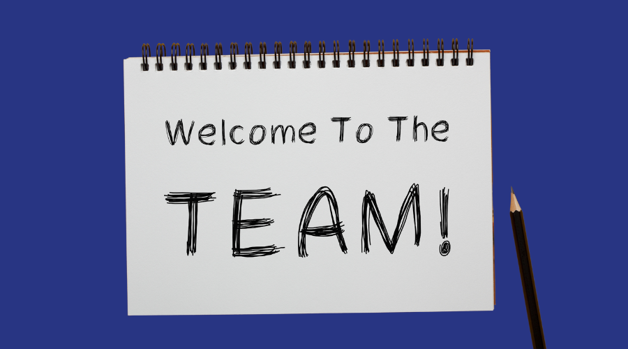 Text on a notepad which says 'Welcome to the Team!'