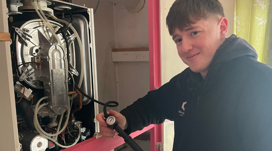 A gas engineer carrying out a boiler service.