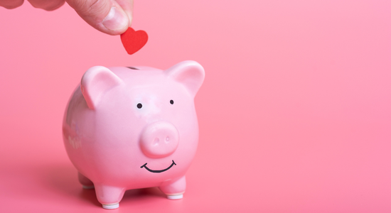 A pink piggy bank on a red background.